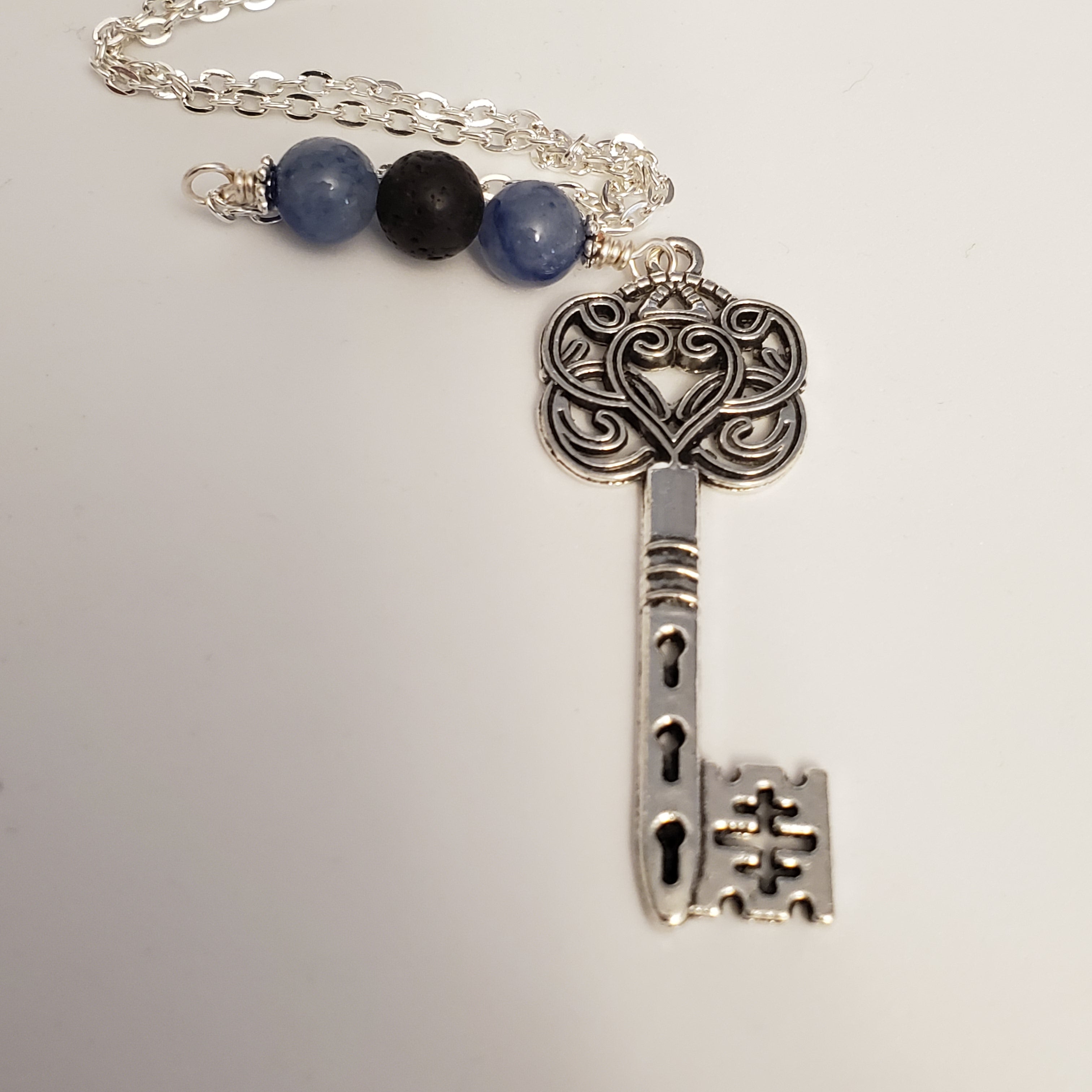 Key necklace with black lava bead and blue jade stone