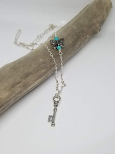 Long chain necklace with key-shaped charm