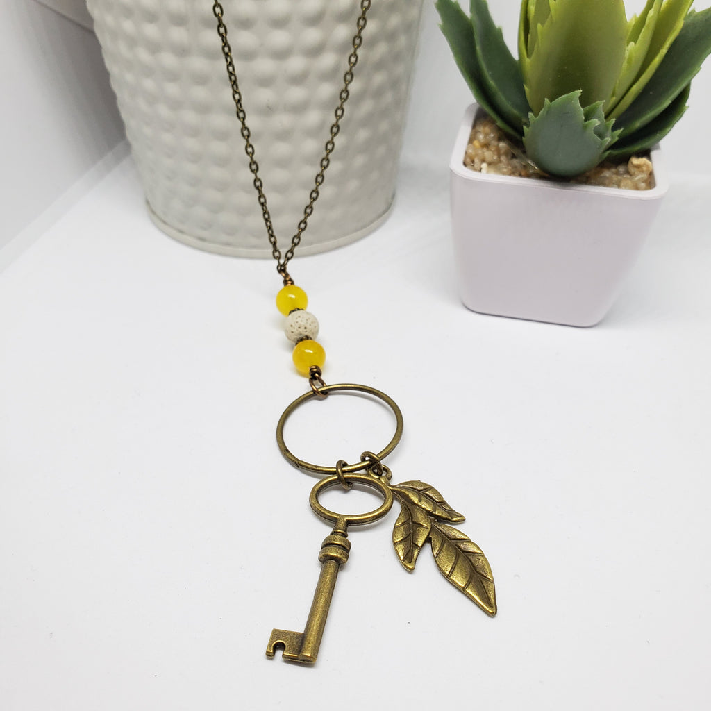 Antique Bronze Key with Yellow Jade Stone White Lava beads.