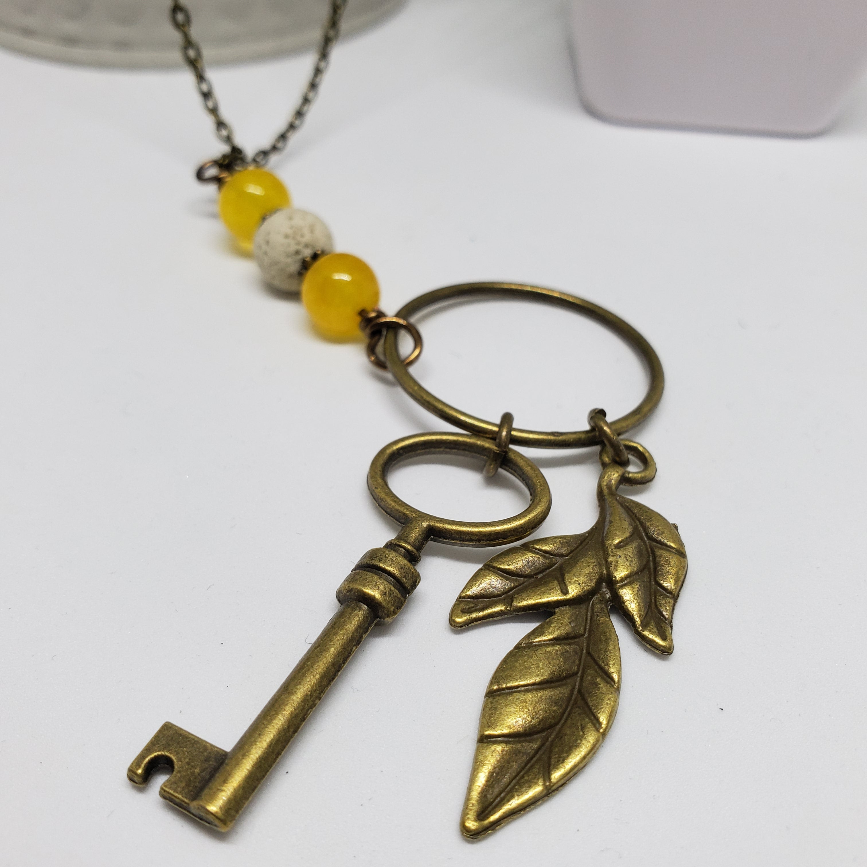 Antique Bronze Key with Yellow Jade Stone White Lava beads.