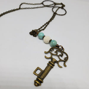 Antique Bronze Key with Turquoise and white lava bead